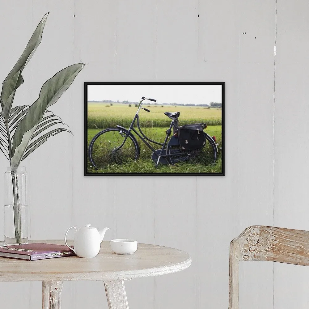 "a bike resting along a fence in the countryside" Black Float Frame Canvas Art