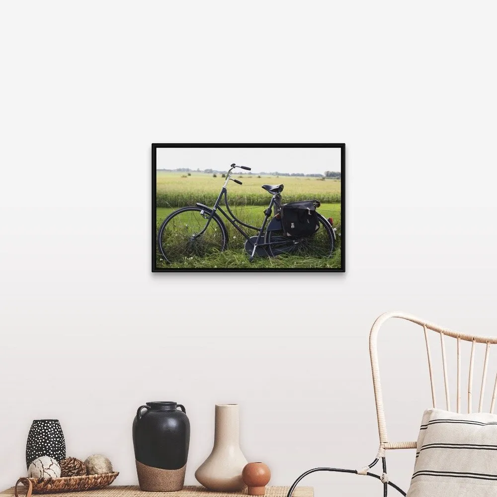 "a bike resting along a fence in the countryside" Black Float Frame Canvas Art