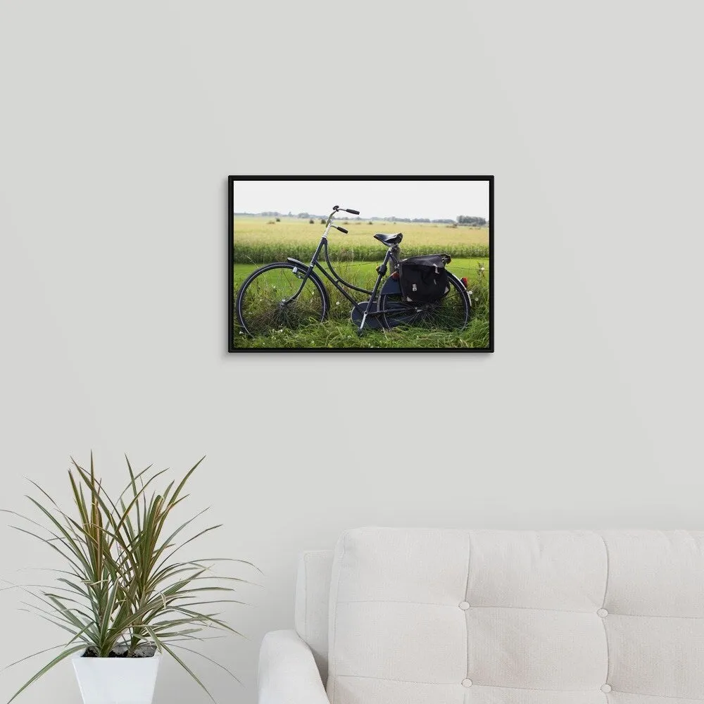 "a bike resting along a fence in the countryside" Black Float Frame Canvas Art