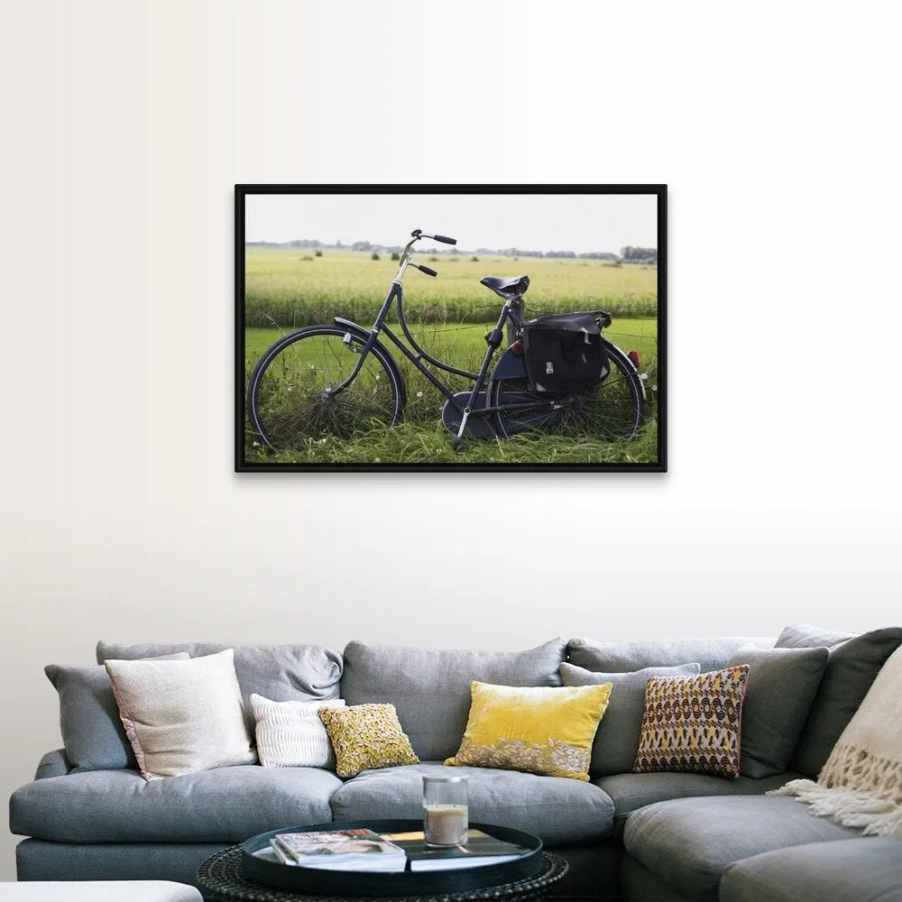 "a bike resting along a fence in the countryside" Black Float Frame Canvas Art