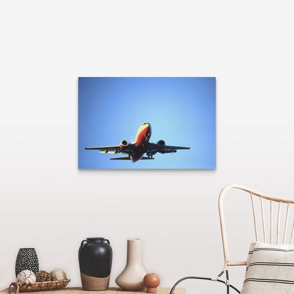 "Aeroplane flying across blue sky" Canvas Wall Art