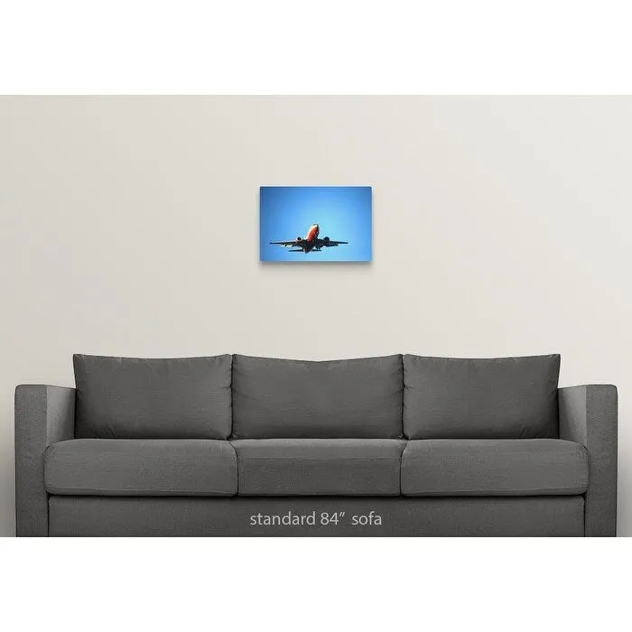"Aeroplane flying across blue sky" Canvas Wall Art