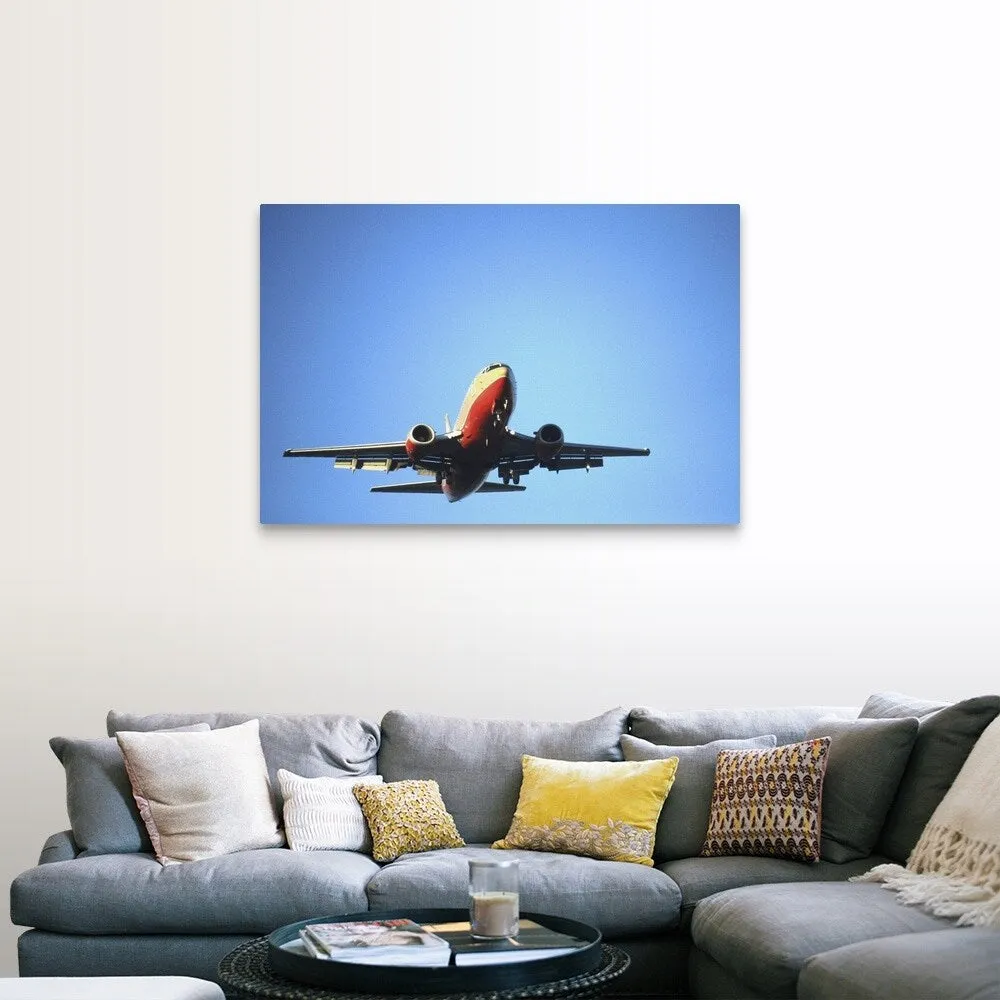 "Aeroplane flying across blue sky" Canvas Wall Art