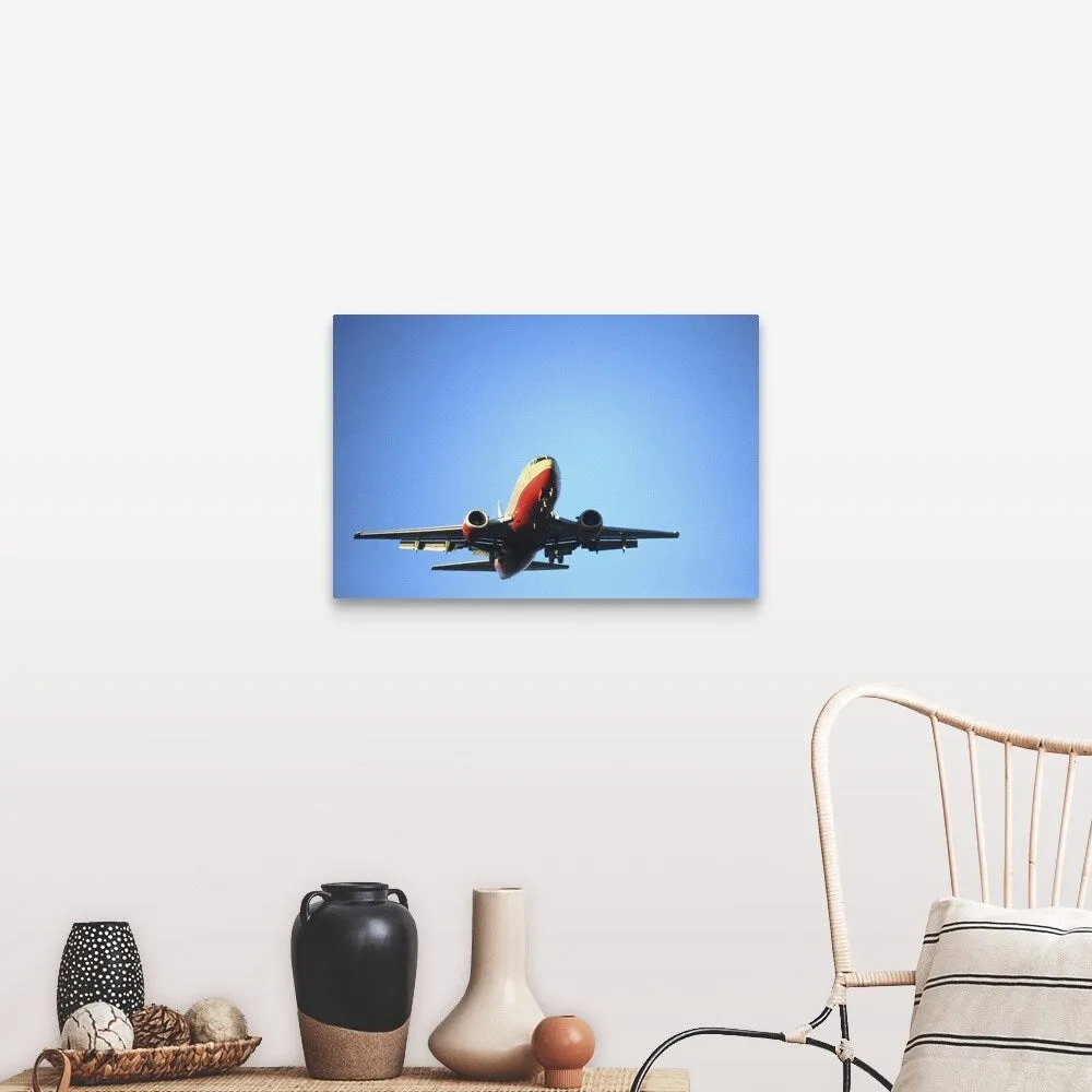 "Aeroplane flying across blue sky" Canvas Wall Art