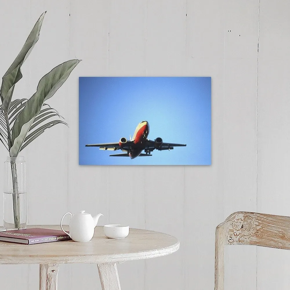 "Aeroplane flying across blue sky" Canvas Wall Art